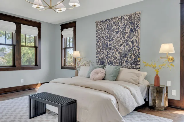 a bedroom with a large bed and a chandelier