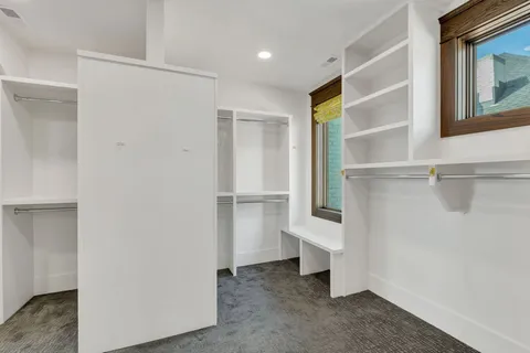 a living room with furniture a flat screen tv and a large window