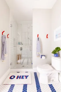 a bedroom with two beds and a potted plant