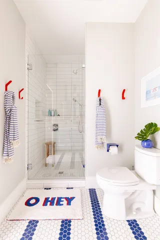 a bedroom with two beds and a potted plant