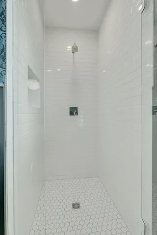 a view of balcony with two chairs and a barbeque