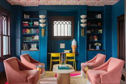 a kitchen that has a kitchen island a sink and a refrigerator