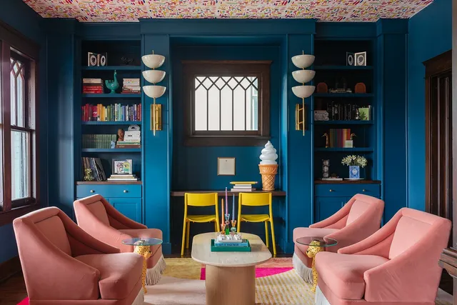 a kitchen that has a kitchen island a sink and a refrigerator