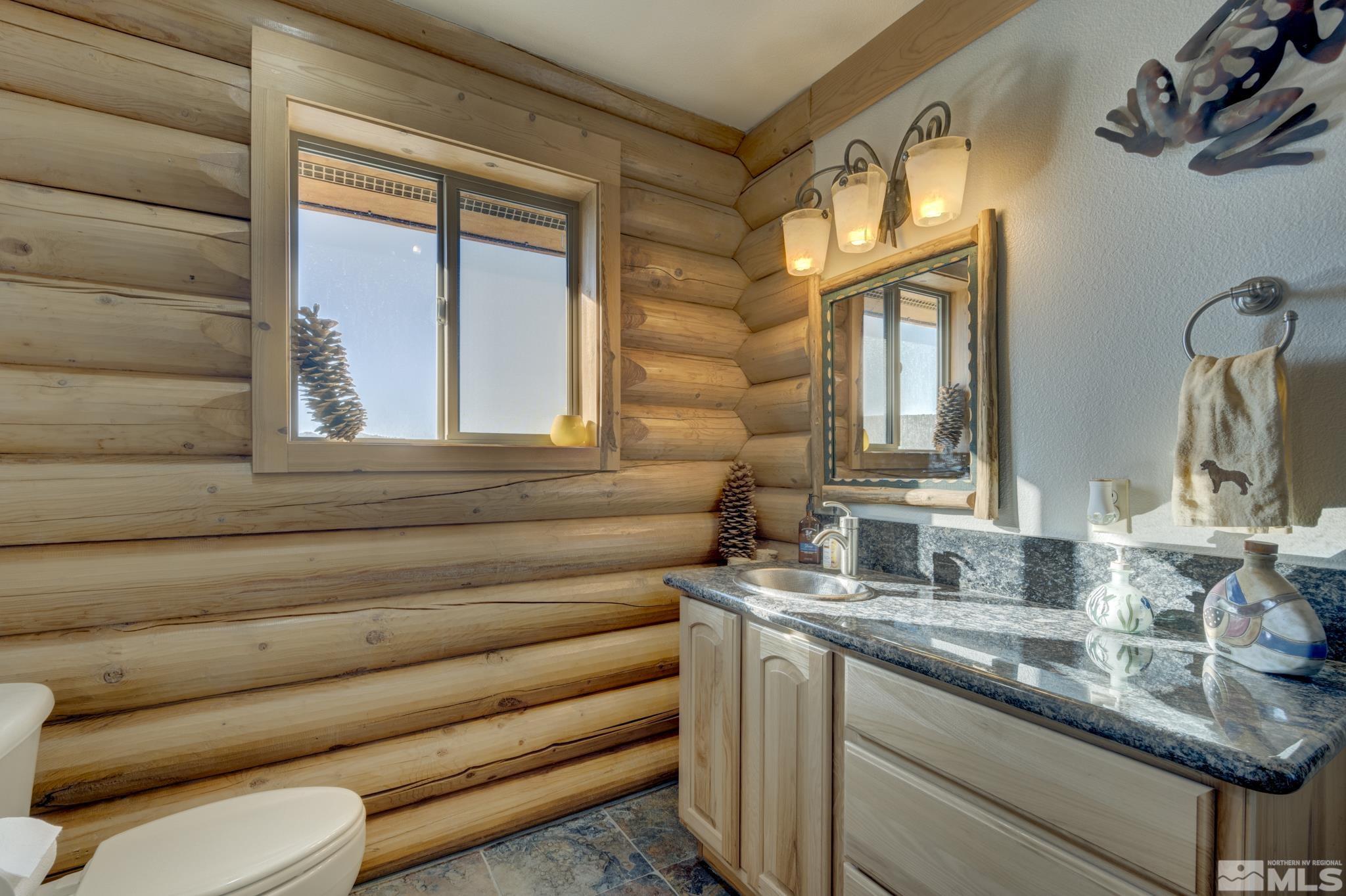 2740 Goldfield Road Reno, NV 89521 - Photo 25 of 39 a bathroom with a granite countertop sink and a mirror