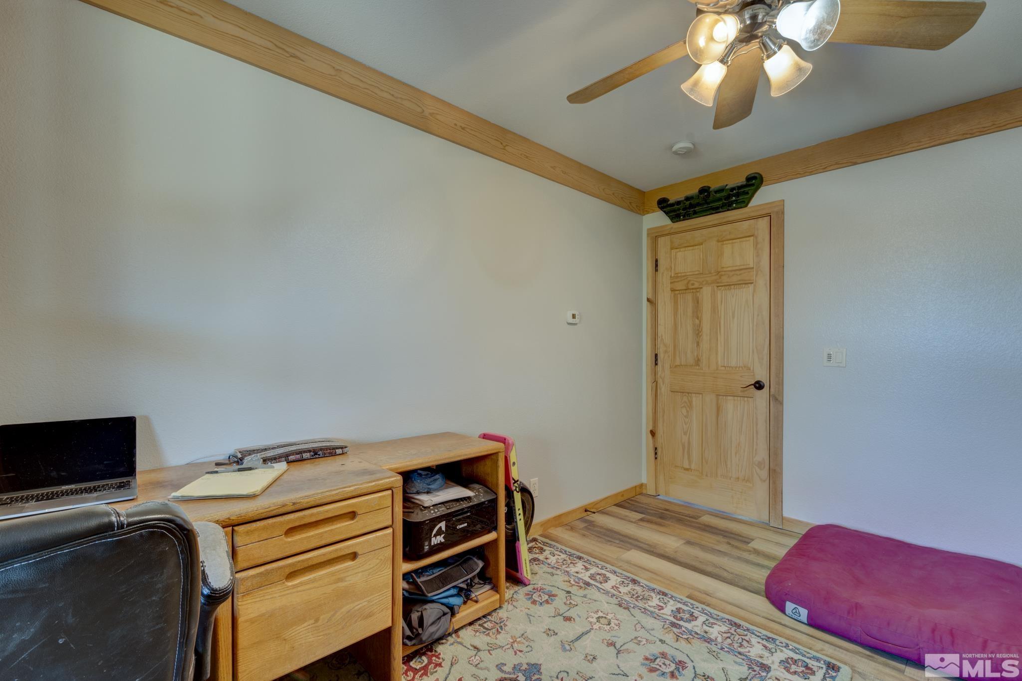 2740 Goldfield Road Reno, NV 89521 - Photo 30 of 39 a bedroom with a bed and a chandelier