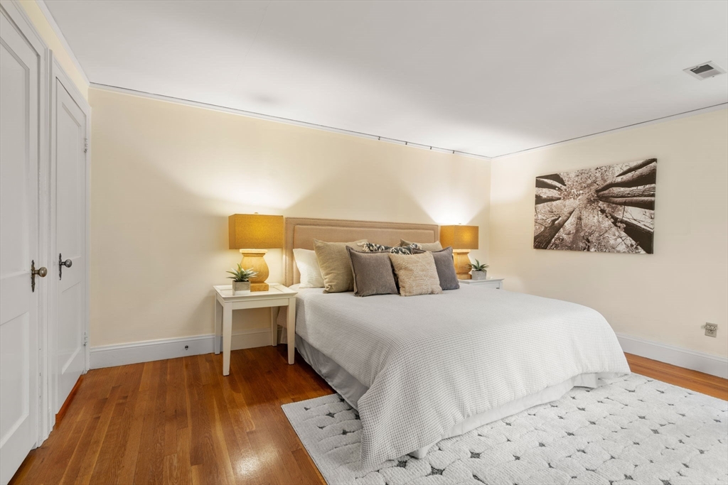 151 Woodcliff Road Newton, MA 02461 - Photo 17 of 33 a bedroom with a bed and a lamp on dresser