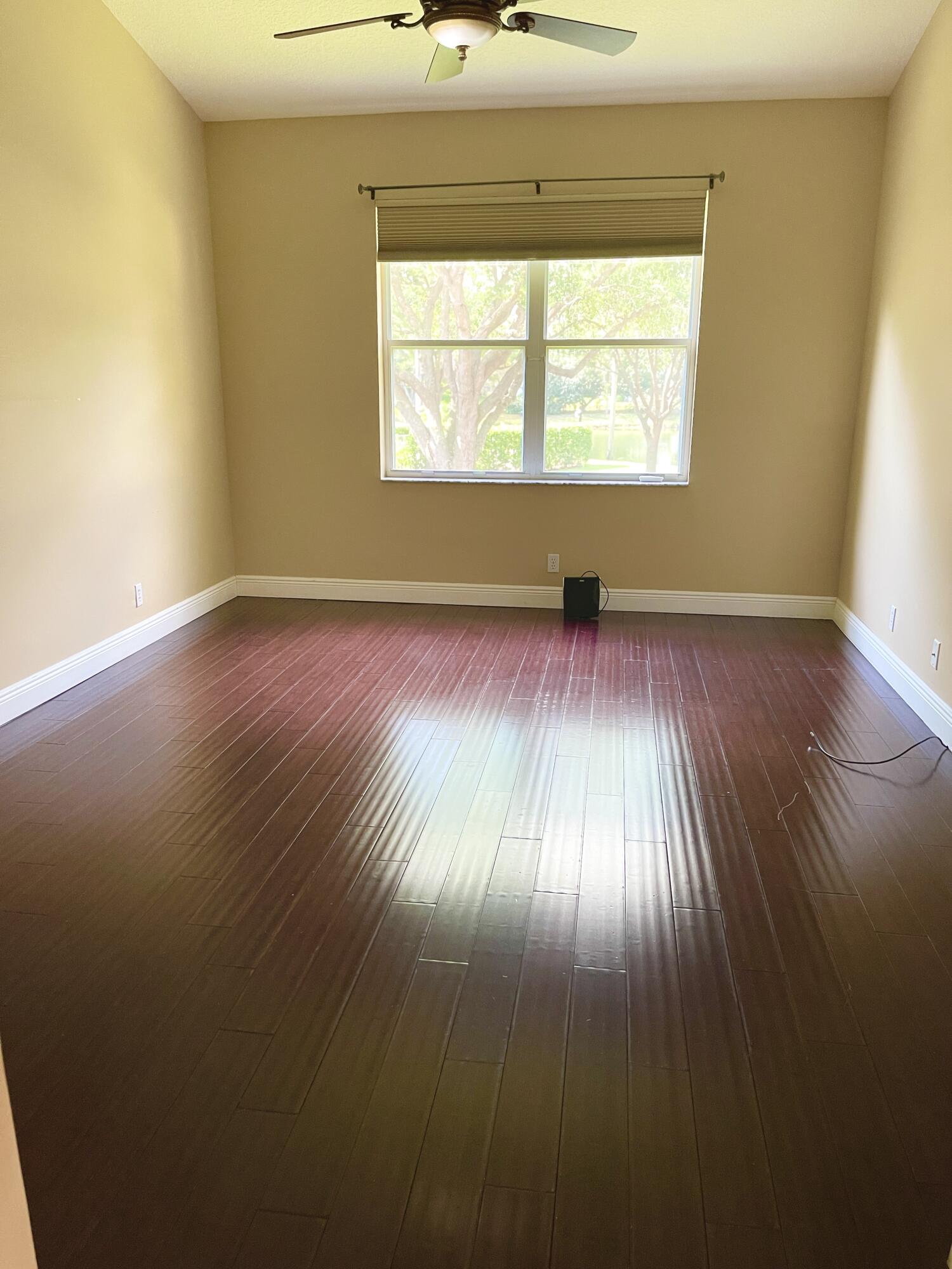 8550 Vía Romana, Unit 2 Boca Raton, FL 33496 - Photo 14 of 28 an empty room with wooden floor and windows