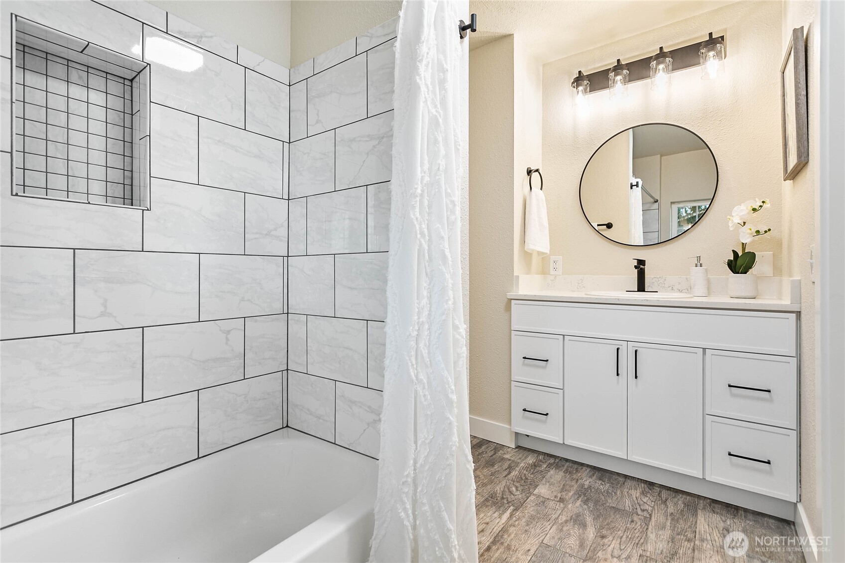 306 West Pole Road Lynden, WA 98264 - Photo 13 of 25 a bathroom with a granite countertop sink a mirror and a bathtub