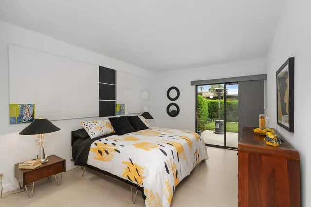 a bed room with a bed and a lamp