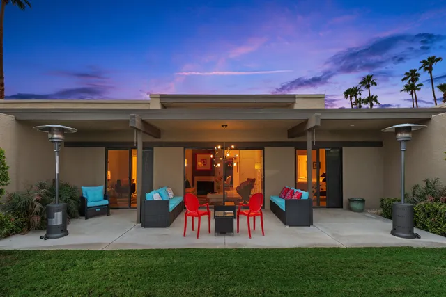 a wooden bench sitting in front of a building