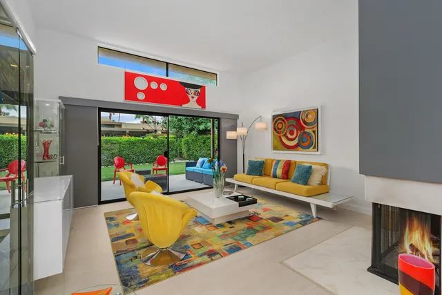 a living room with furniture and a floor to ceiling window