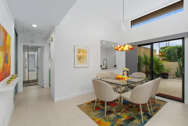 a dining room with furniture and wooden floor