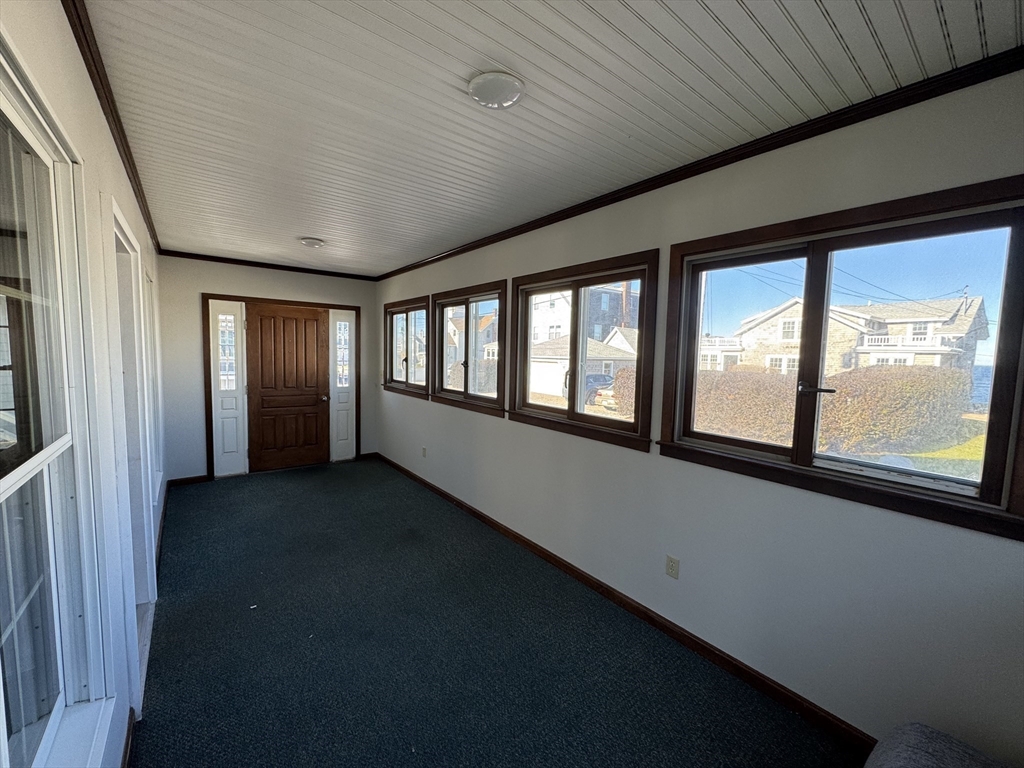 23 Gunrock Avenue Hull, MA 02045 - Photo 4 of 30 a view of an empty room with a window and wooden floor