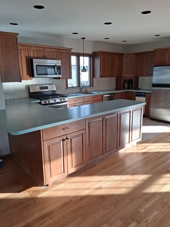 23 Gunrock Avenue Hull, MA 02045 - Photo 9 of 30 a kitchen with stainless steel appliances granite countertop a stove a sink and a microwave