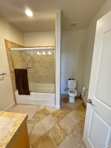 a bathroom with a toilet and a shower