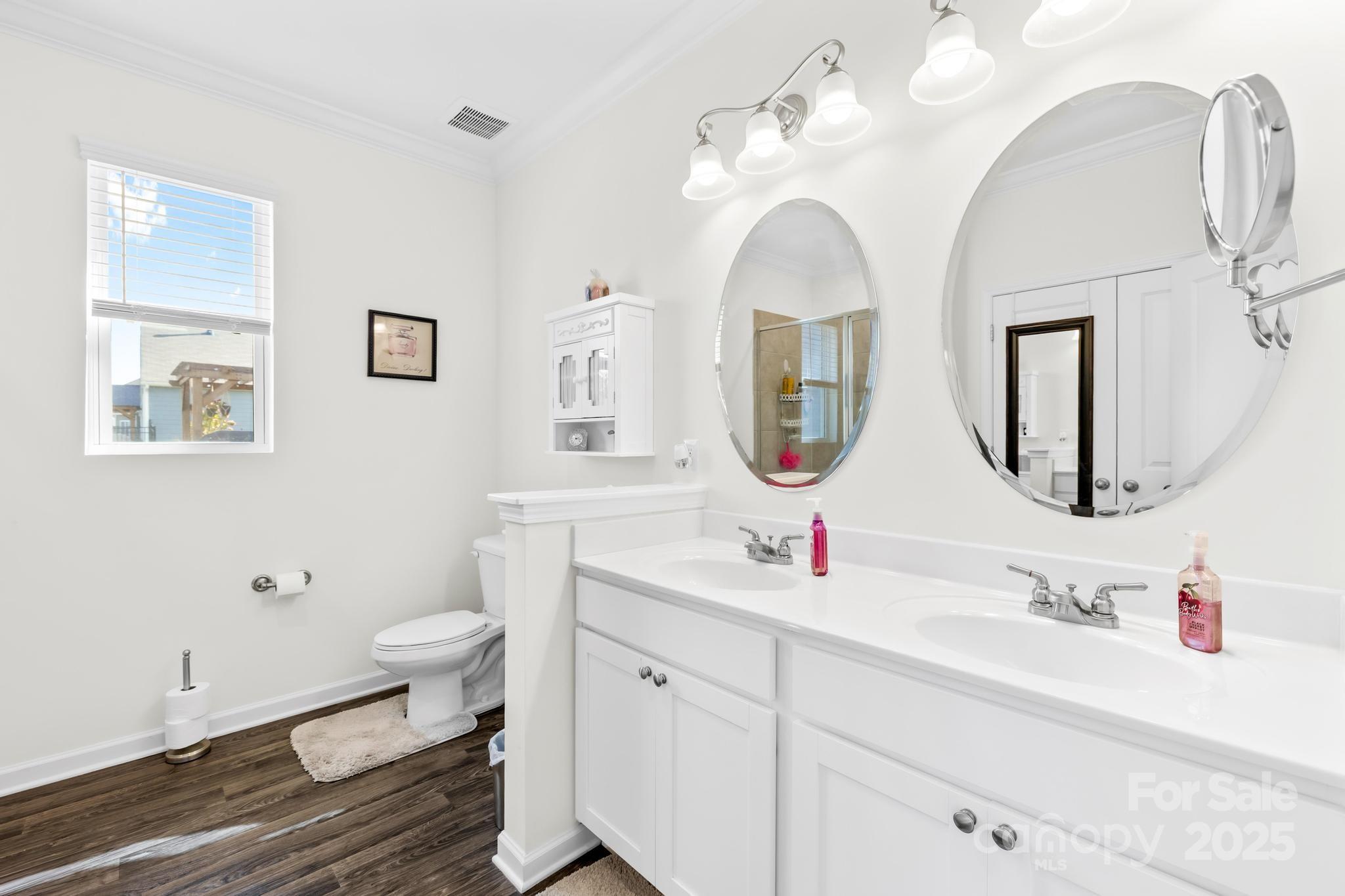 128 West Neel Ranch Road Mooresville, NC 28115 - Photo 11 of 27 a bathroom with a toilet sink and mirror