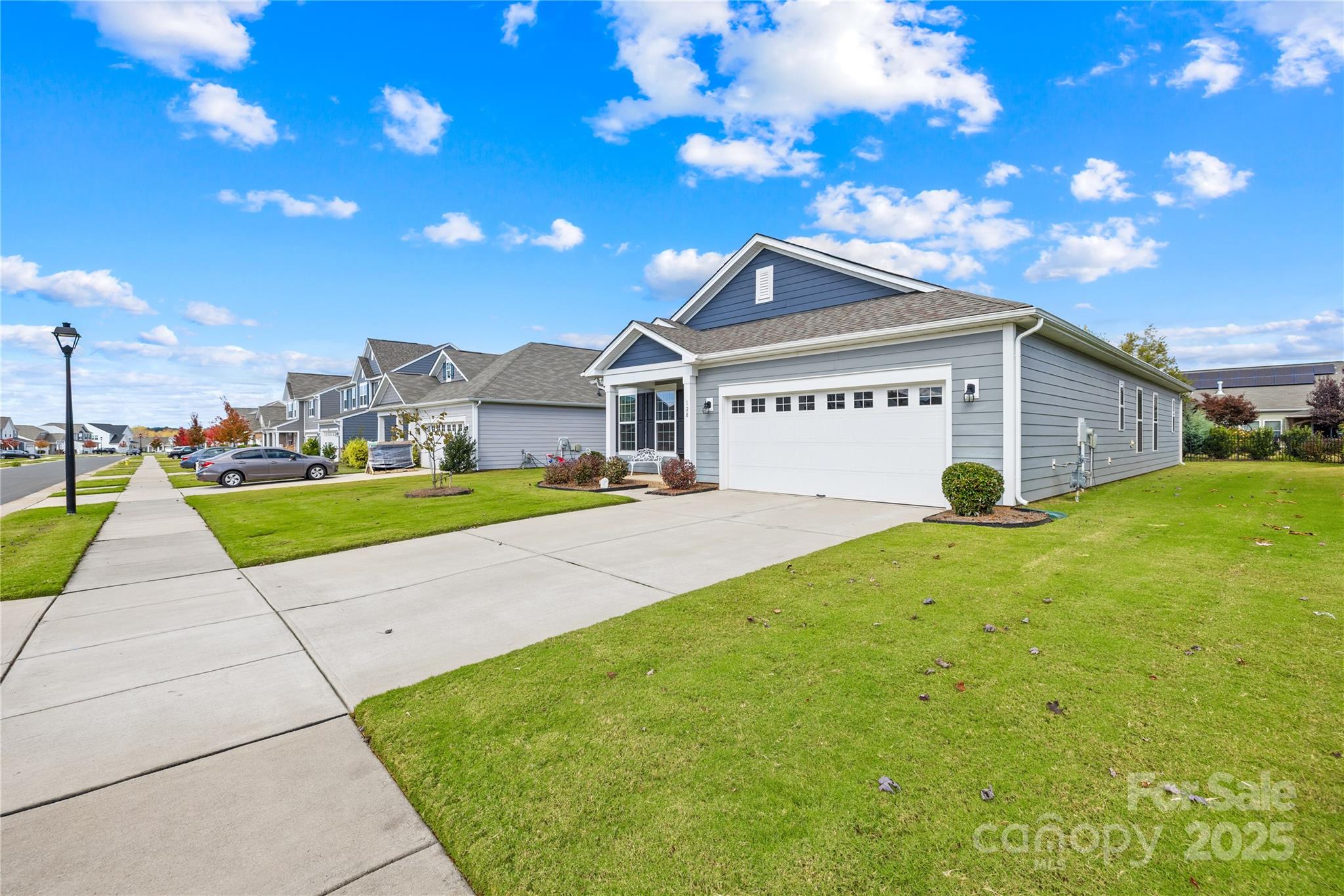 128 West Neel Ranch Road Mooresville, NC 28115 - Photo 23 of 27 a front view of a house with a yard and garage