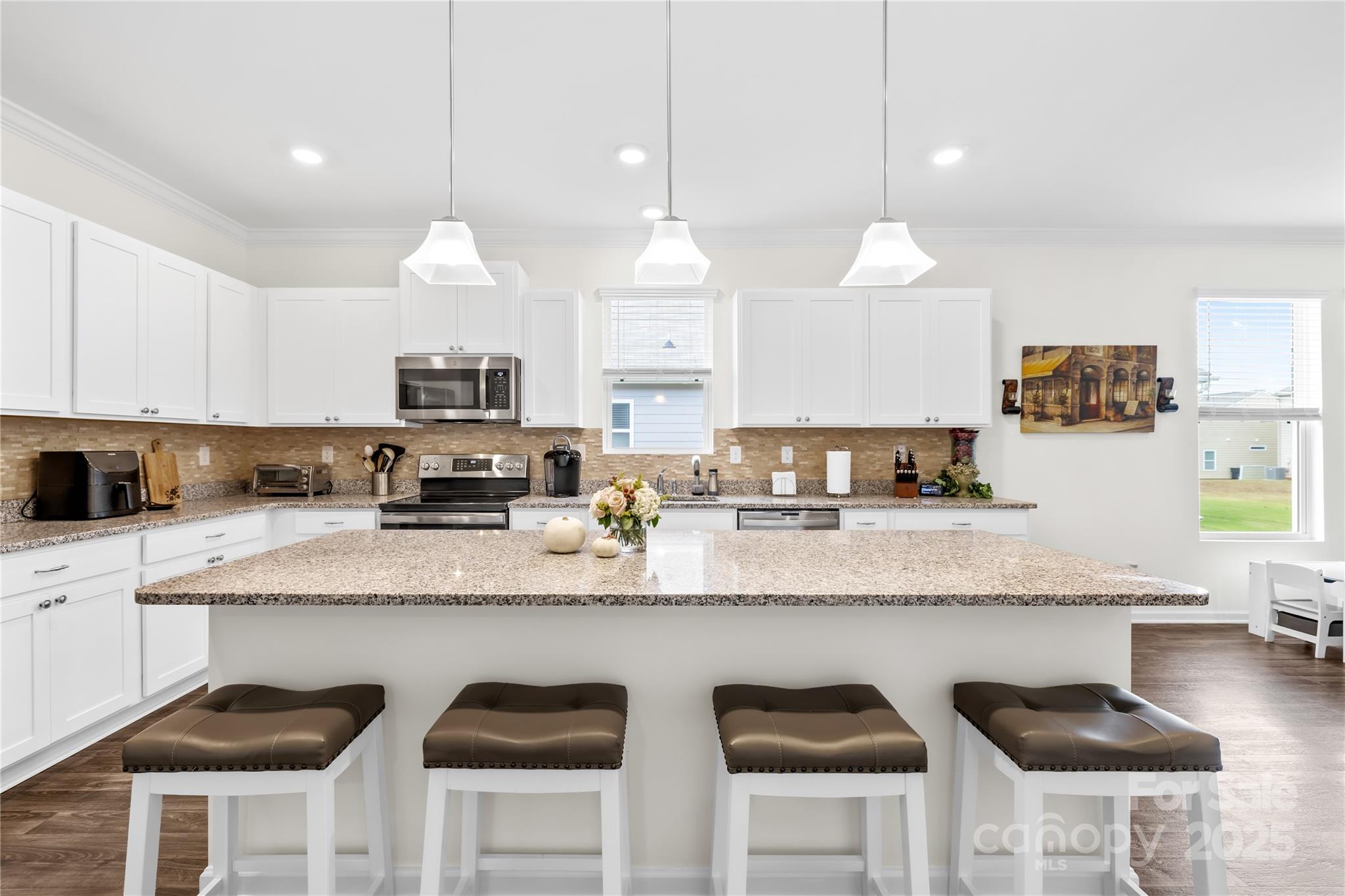 128 West Neel Ranch Road Mooresville, NC 28115 - Photo 7 of 27 a large kitchen with granite countertop lots of counter space white cabinets and stainless steel appliances