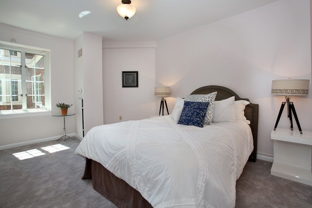 20 Chapel Street, Unit B411 Brookline, MA 02446 - Photo 11 of 18 a bedroom with bed and window
