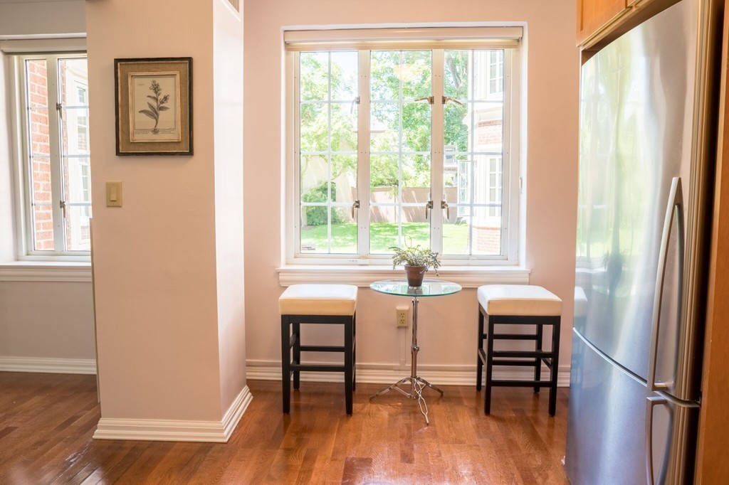 20 Chapel Street, Unit B411 Brookline, MA 02446 - Photo 6 of 18 a view of a dining room with furniture and wooden floor