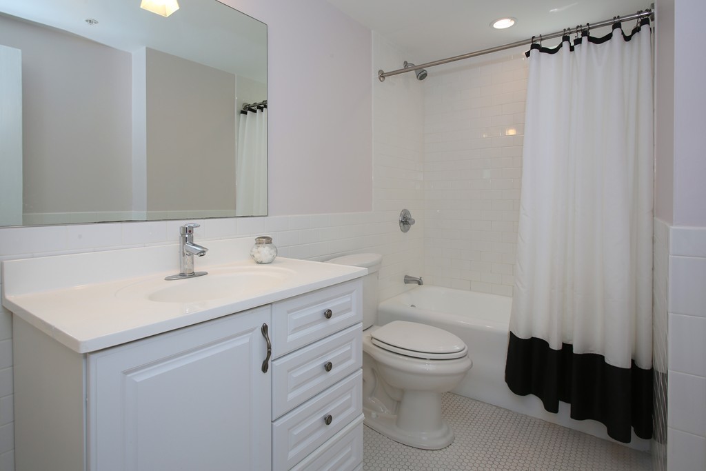 20 Chapel Street, Unit B411 Brookline, MA 02446 - Photo 10 of 18 a bathroom with a sink toilet vanity and shower