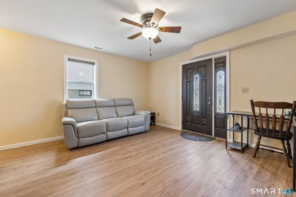 a living room with furniture and a wooden floor