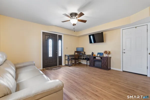 a living room with furniture and a wooden floor