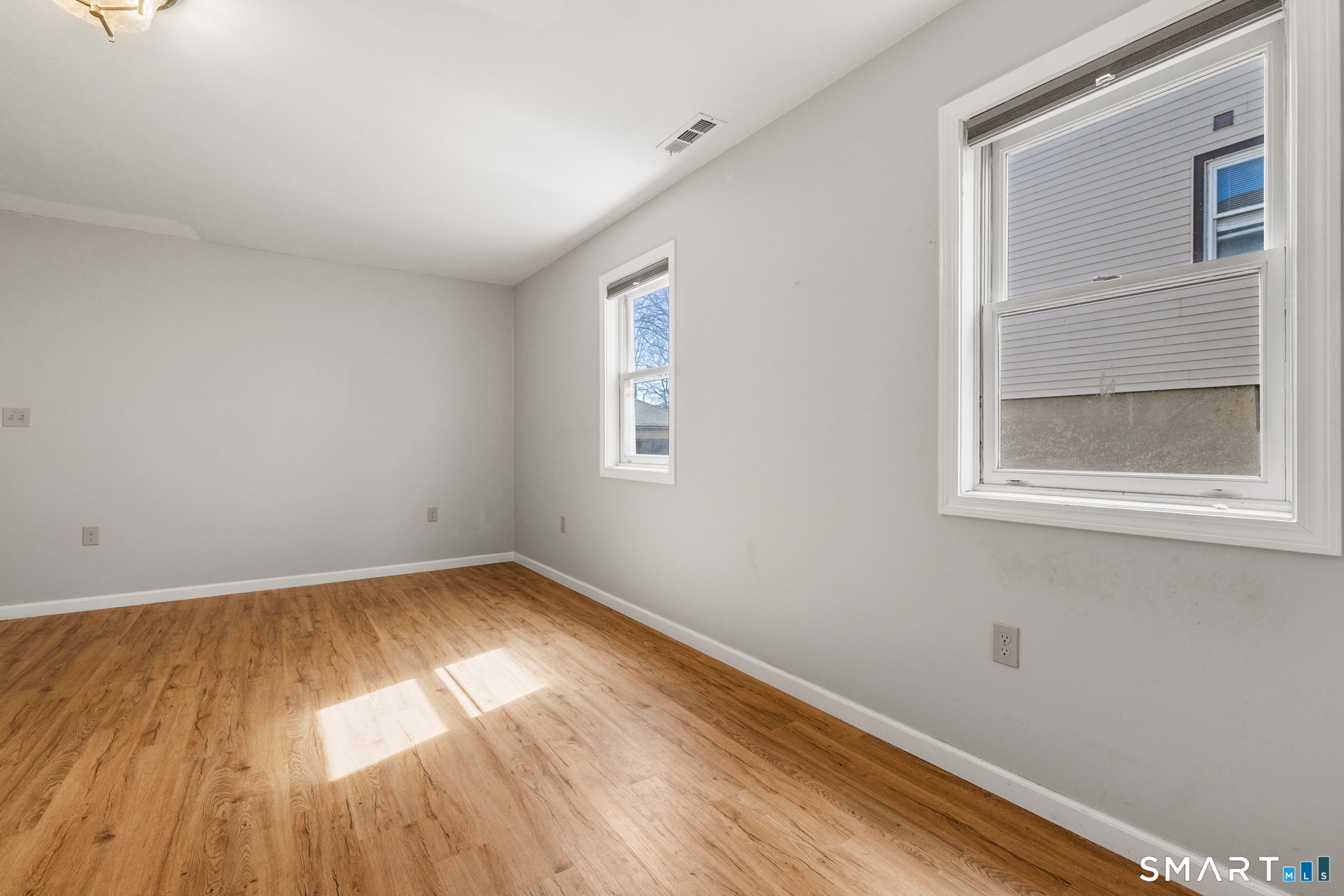 132 Howard Avenue Ansonia, CT 06401 - Photo 15 of 41 a view of empty room with wooden floor and fan