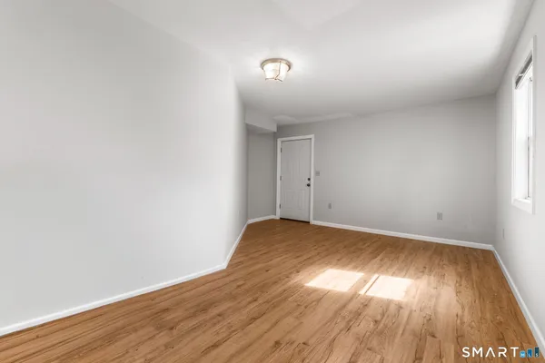 a view of room with wooden floor and fan