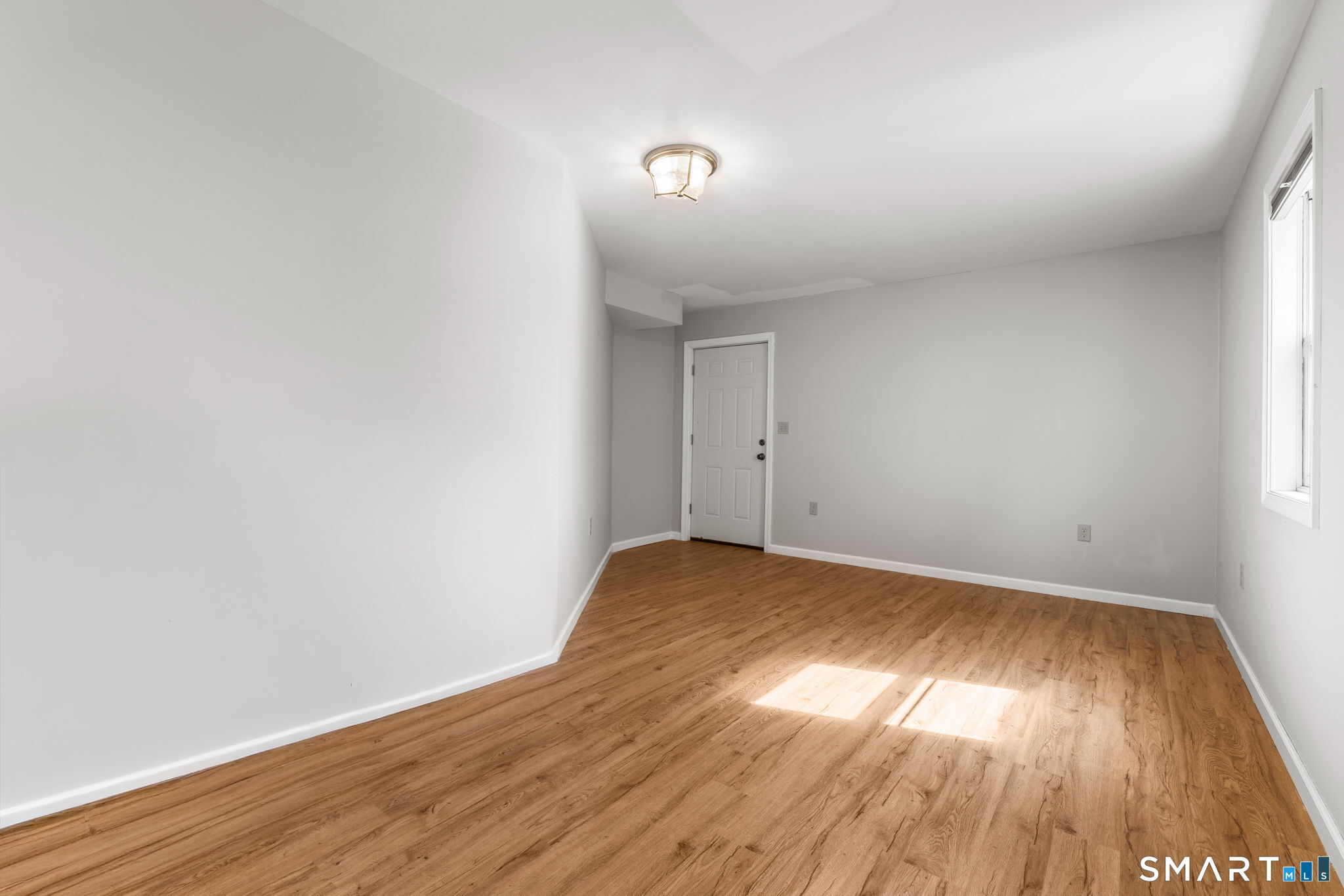 132 Howard Avenue Ansonia, CT 06401 - Photo 16 of 41 a view of room with wooden floor and fan