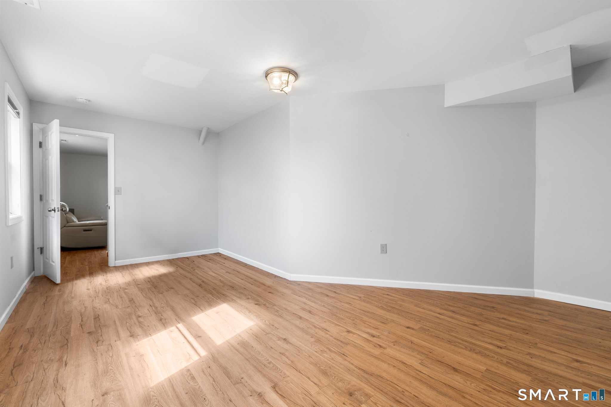 132 Howard Avenue Ansonia, CT 06401 - Photo 17 of 41 a view of a livingroom with wooden floor and a bathroom