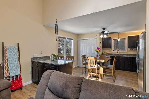 a living room with furniture a dining table and kitchen view