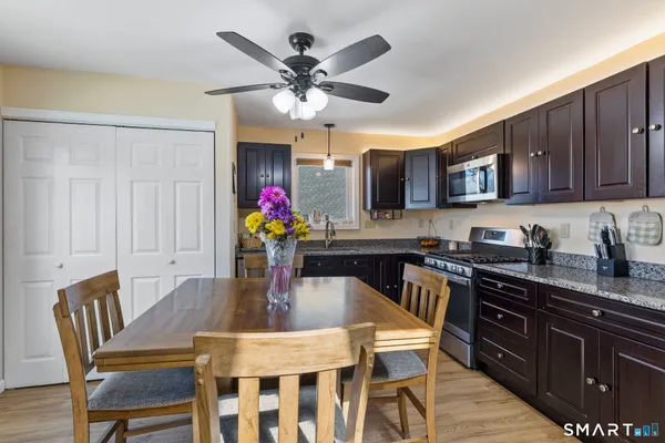 a dining table with chairs and kitchen view