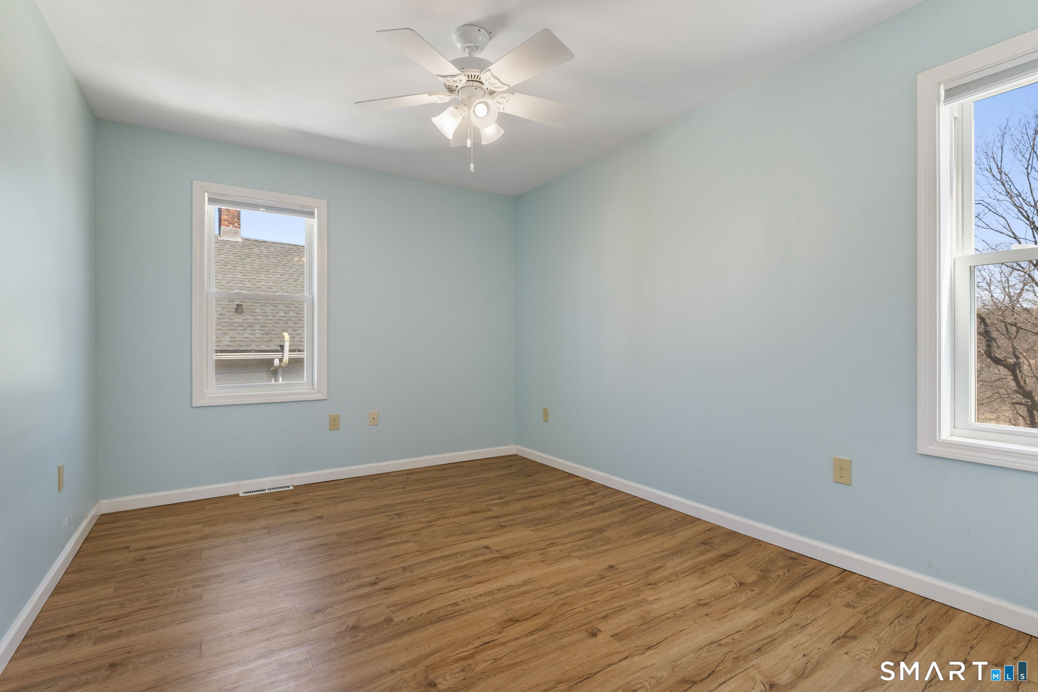 132 Howard Avenue Ansonia, CT 06401 - Photo 33 of 41 a view of empty room with wooden floor and fan