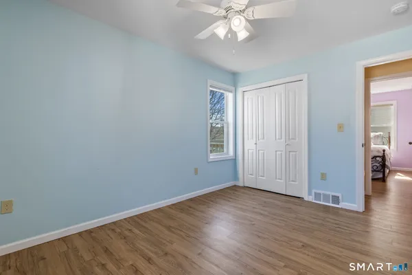 a view of an empty room with wooden floor