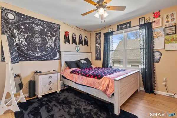 a bedroom with a bed and a window