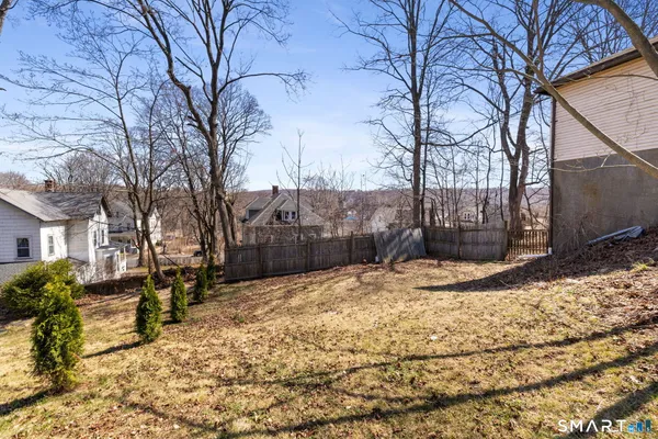 a view of a yard covered with snow in front of house