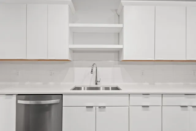 a bathroom with double vanity sinks and a mirror