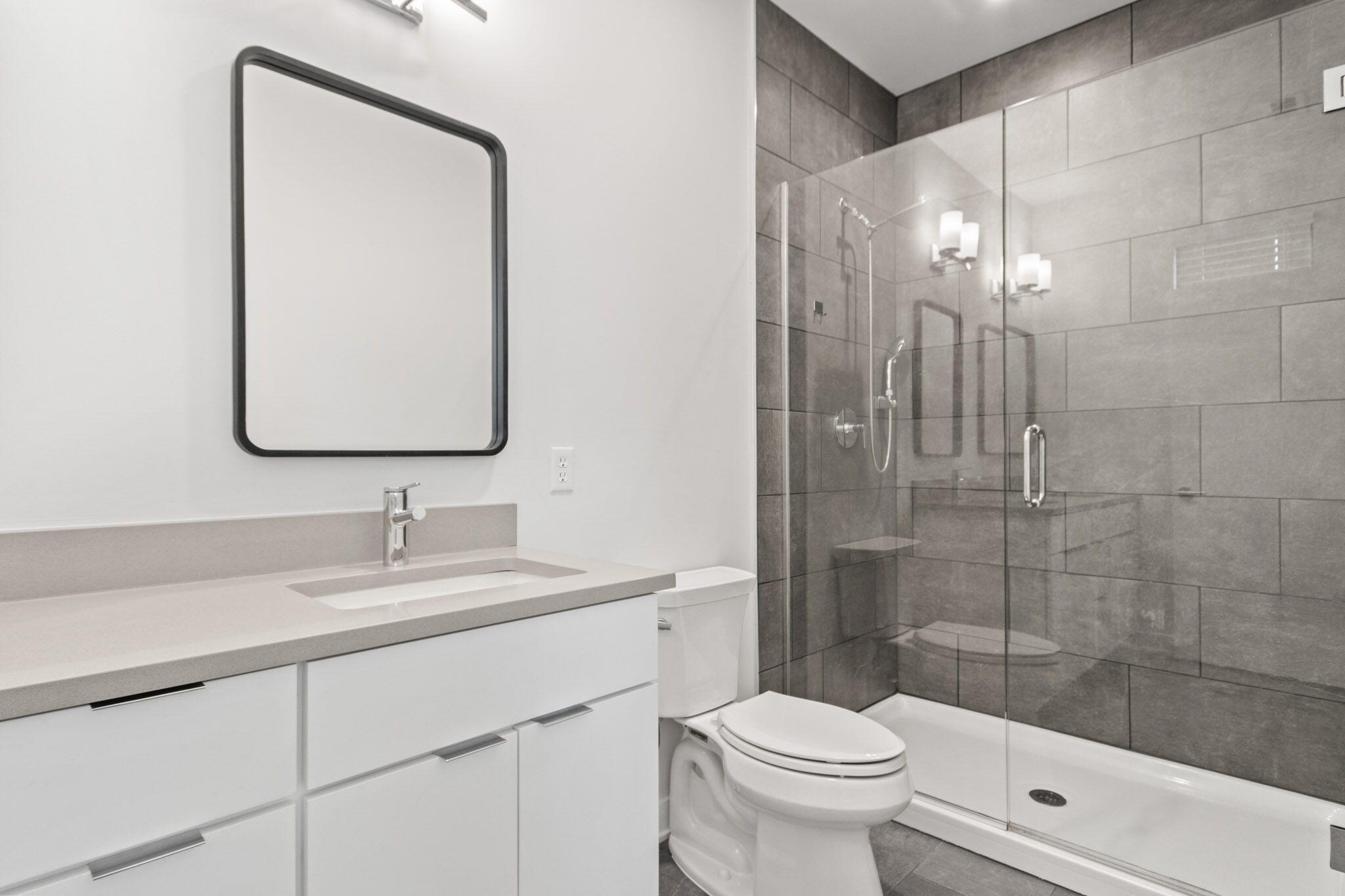 255 Nomo Place Crown Point, IN 46307 - Photo 41 of 83 a bathroom with a toilet a sink a glass door a shower a mirror and vanity