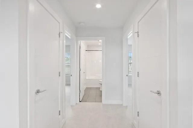 an aerial view of residential houses with outdoor space and ocean view