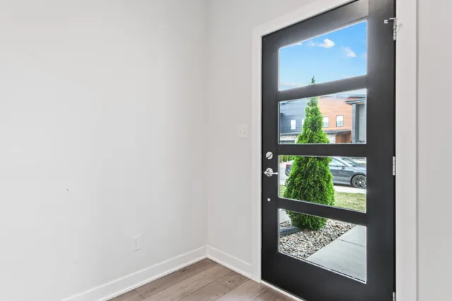 a view of entryway and hall with wooden floor