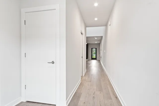a view of a kitchen with wooden floor and electronic appliances