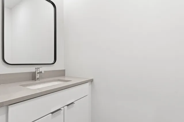 a kitchen with stainless steel appliances a refrigerator and wooden floor