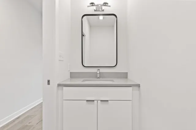 a kitchen with stainless steel appliances granite countertop a sink dishwasher a stove and a refrigerator with wooden floor