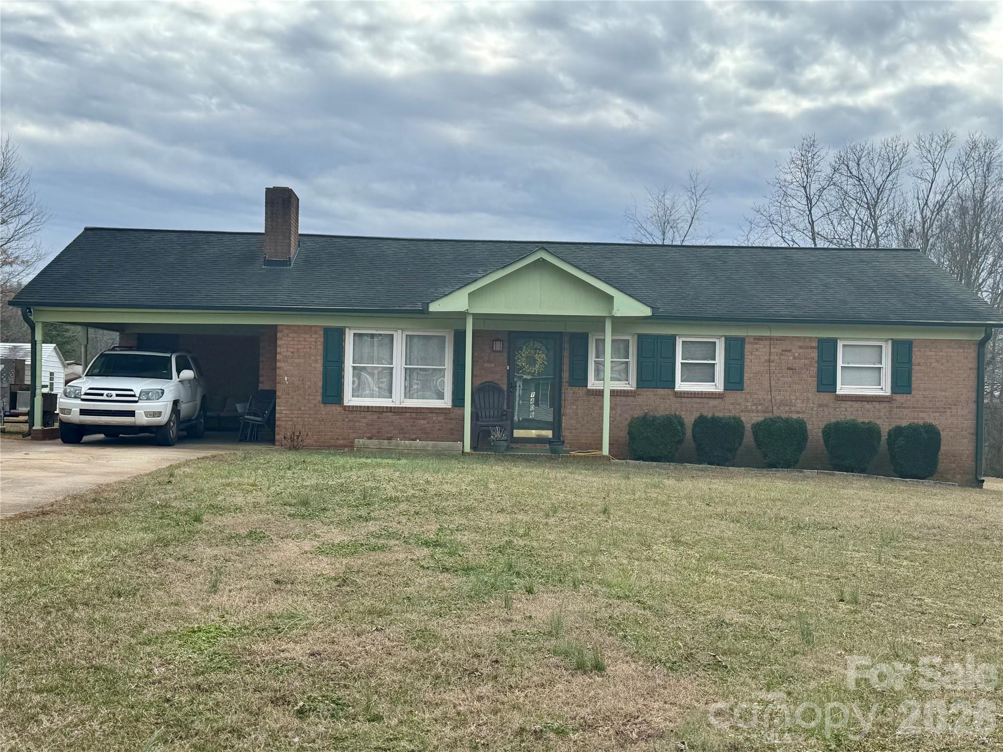 a front view of a house with a garden