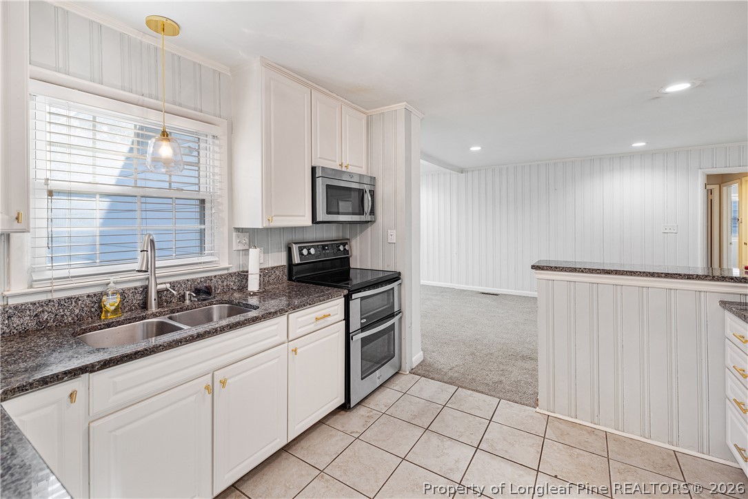 2527 Huntington Road Fayetteville, NC 28303 - Photo 12 of 39 a kitchen with stainless steel appliances granite countertop a sink and a stove