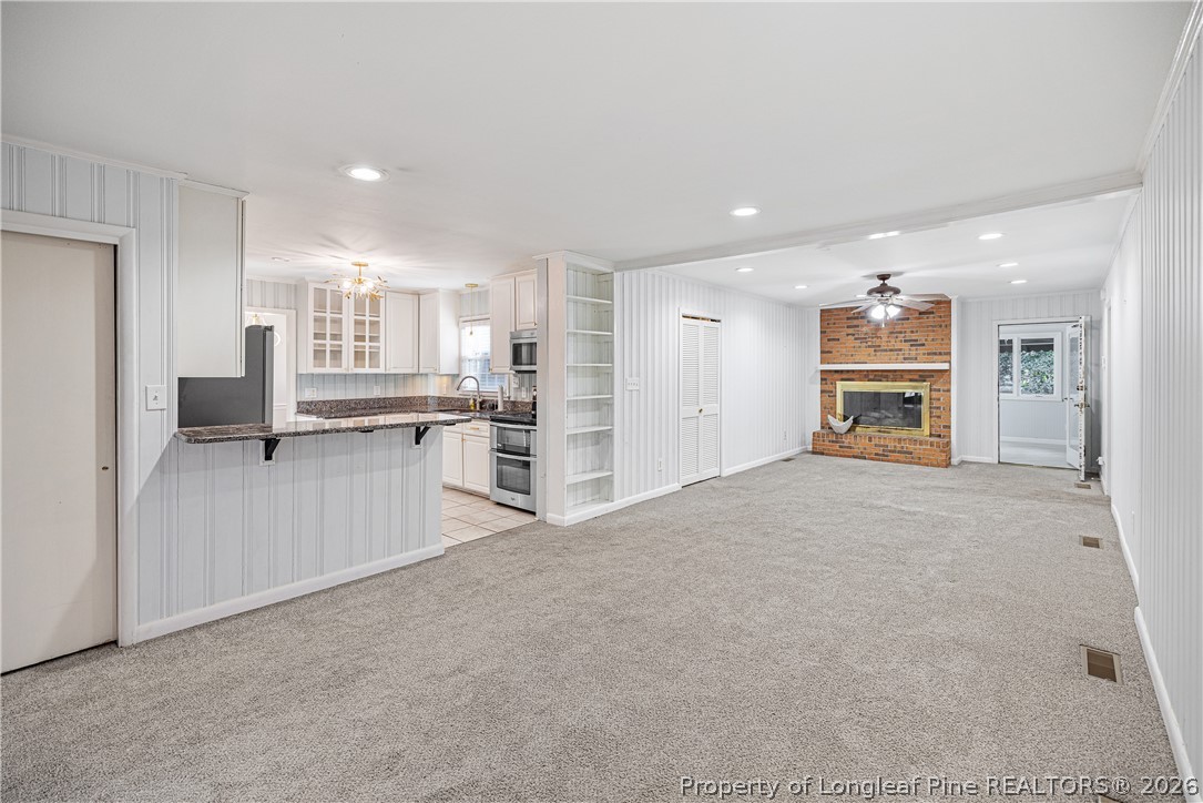 2527 Huntington Road Fayetteville, NC 28303 - Photo 14 of 39 a living room with furniture and a kitchen