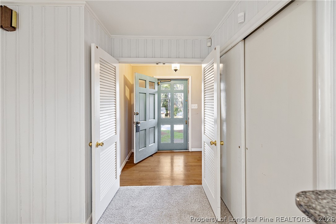 2527 Huntington Road Fayetteville, NC 28303 - Photo 15 of 39 a view of a hallway with wooden floor and a living room