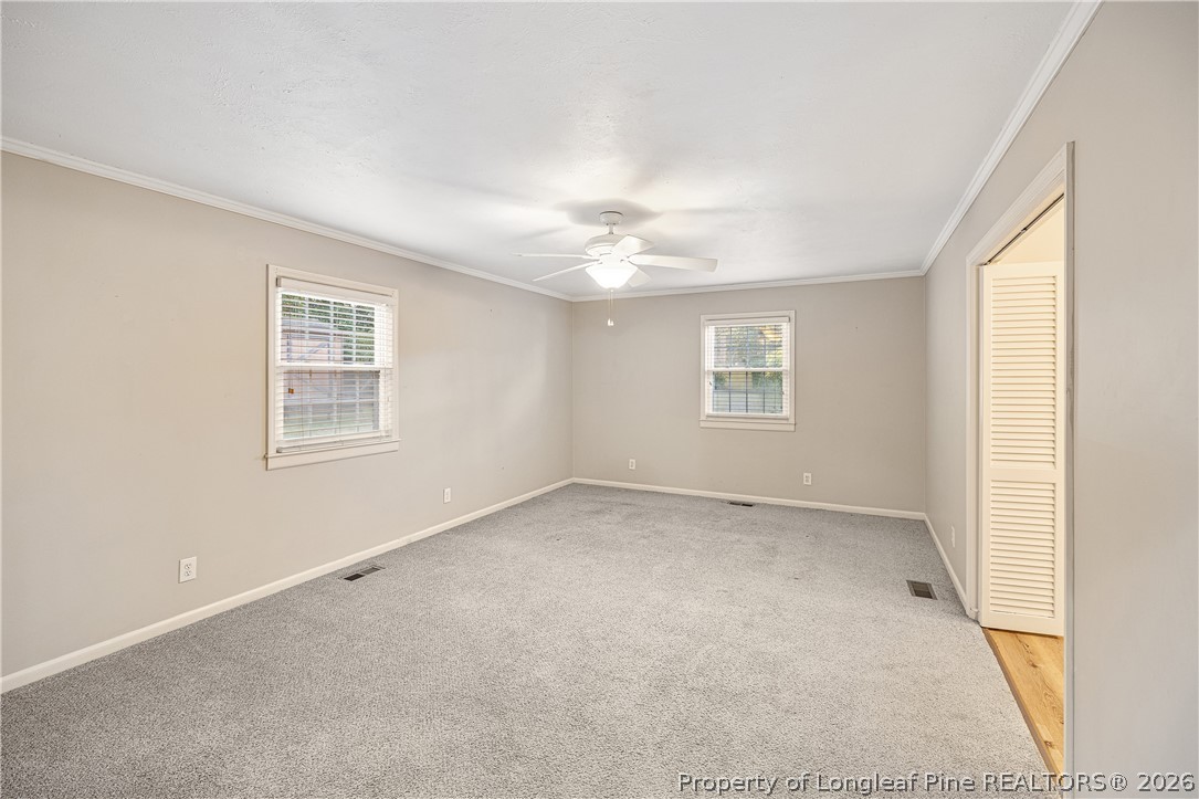 2527 Huntington Road Fayetteville, NC 28303 - Photo 19 of 39 an empty room with a window and a ceiling fan