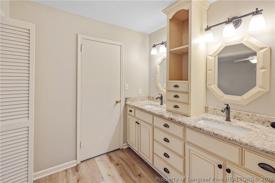 2527 Huntington Road Fayetteville, NC 28303 - Photo 23 of 39 a bathroom with a granite countertop double vanity sink mirror and